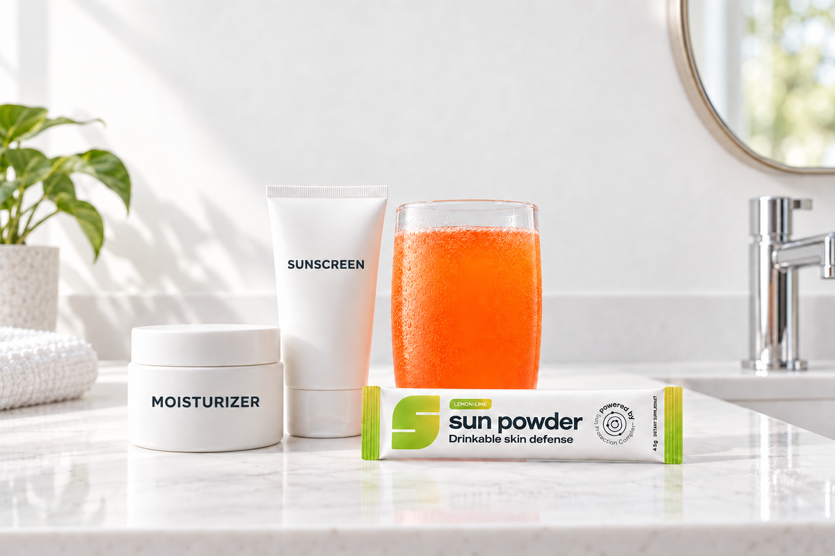 Sunscreen and moisturizer on a vanity beside a glass of Sun Powder